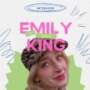 A stylized graphic introducing an interview with sex therapist Emily King. The background is light with hand-drawn blue and pink doodles. Large pink text reads “EMILY KING,” with small green labels above the words saying “SEX” and “THERAPIST.” Below, there is a portrait of Emily King wearing a patterned beret, smiling softly at the camera.