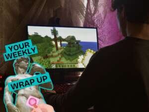 A person sits at a desk playing a video game on a computer monitor showing a block-style landscape. On the left, a graphic reads “Your Weekly Wrap Up” beside a stylised classical statue outlined in teal, partially covered by a pink censor-style sticker.