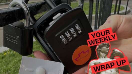 Close-up of a hand holding a blister pack with a single pill next to a black combination padlock attached to a metal fence outdoors. Overlaid graphic reads “Your Weekly Wrap Up” in bold red text, alongside a stylised image of a classical statue partially covered with a pink sticker.
