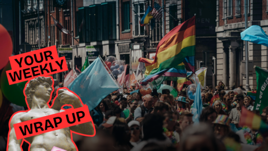 Crowds gather at a Pride march in a city street, with rainbow and transgender flags visible above the crowd. A “Your Weekly Wrap Up” graphic featuring a classical statue and a condom illustration appears in the bottom left corner.