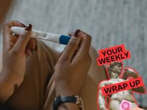 Close-up of a person holding a positive pregnancy test in both hands. A graphic in the corner reads “Your Weekly Wrap Up” alongside a classical statue and a small condom illustration.