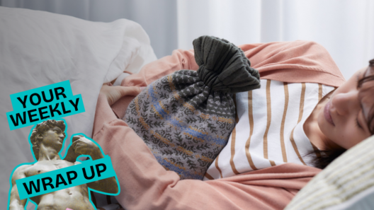 A person lies curled on their side in bed, holding a hot water bottle against their abdomen. A “Your Weekly Wrap Up” graphic with a classical statue and condom illustration appears in the lower-left corner.